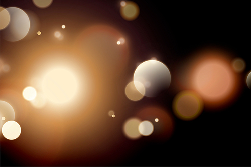 Glittering golden bokeh effect background for design uses