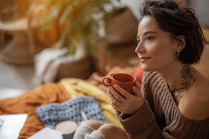 Happy attractive lady with cup of tea at home stock photo