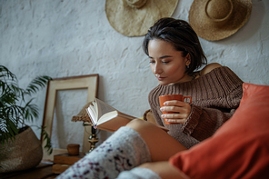 Beautiful lady reading book and enjoying tea stock photo