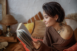 Side view of woman leafing through pages of a book stock photo