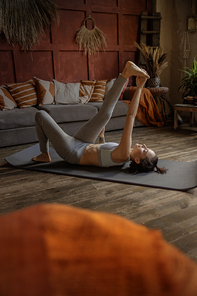 Young woman stretching at home in the morning stock photo