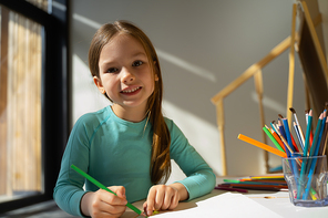 Adorable child with pencil  and smiling stock photo