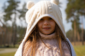 Cute child wearing warm fluffy hood with ears stock photo