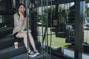 Pretty Asian girl talking on mobile phone. Leisure time concept