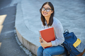 Smiling girl with notebook outdoors stock photo