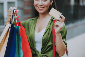 Happy Asian lady with bags and payment card stock photo