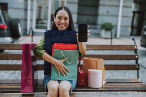 Pretty lady with bags and mobile phone stock photo
