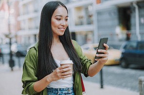 Smiling Asian woman doing selfie in the city stock photo