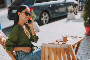 Happy young lady enjoying coffee in cafe stock photo