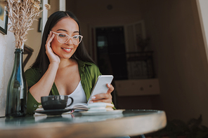 Happy woman in glasses with smartphone stock photo