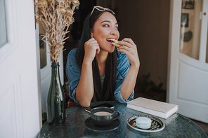 Happy lady eating macaroon stock photo