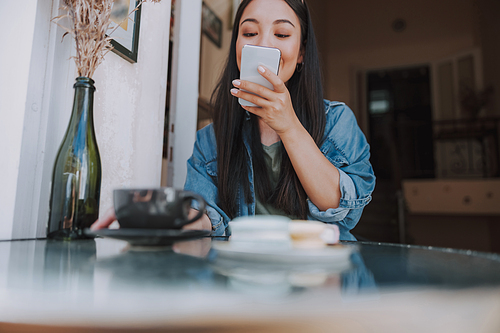 Smiling young woman with smartphone stock phoo