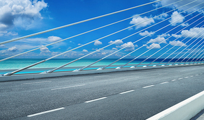 Modern cable-stayed bridge speedway with seascape .Side angle view . Morning scene .