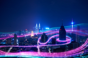 Night city and abstract with gradient blue and red glowing light trail surround the city ,Smart city big data connection technology concept .