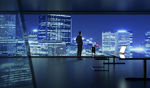Rear view of successful businessman looking the city from his office , night scene .