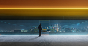 Businessman standing in office watching city night view . Business ambition and vision concept .