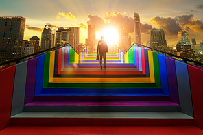 Businessman climbing on colorful stair to modern city, ambitions concept .