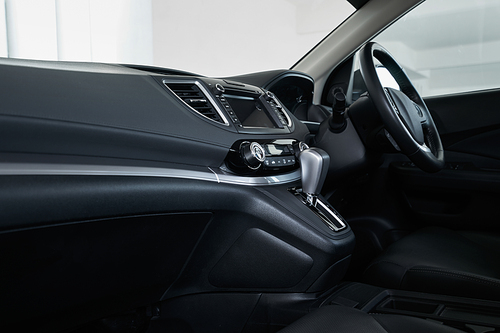 Modern black car dashboard interior , luxury car interior concept . Side profile angle .