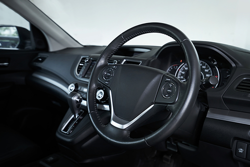 Modern black car dashboard interior , luxury car interior concept . Side profile angle .