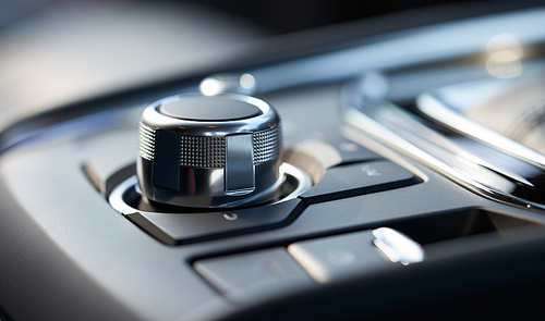 Closeup of a modern car interior with media and navigation control buttons
