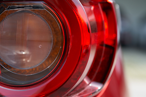 Close up detail of the rear tail light of a red car
