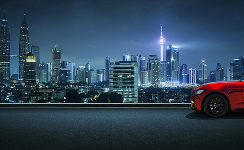 Sport car parked on road side with night sky cityscape background .