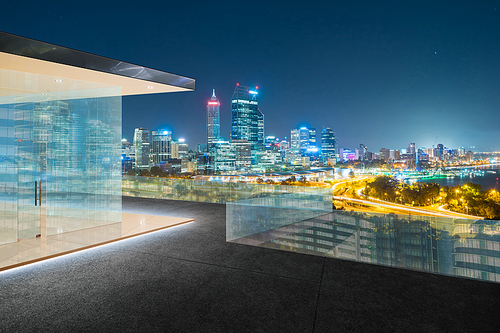 Modern city skyline at night with balcony view .