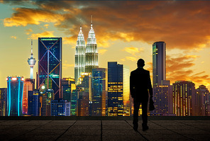 The silhouette portrait
of businessman on the roof to see the scenery. Concept of vision of the future .