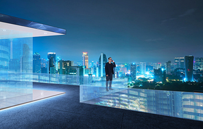Businessman talking phone at modern rooftop with beautiful city skyline , night scene .