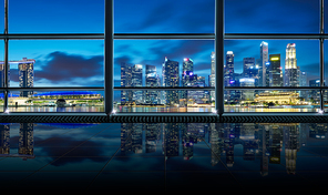 Modern empty and clean office interior with glass windows , Singapore city skyline background , early morning scene .
