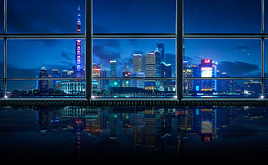 Modern empty and clean office interior with glass windows , shanghai pudong city skyline background , night scene .