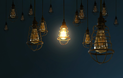 Hanging retro light bulbs decor on dark blue background with one isolated glowing .