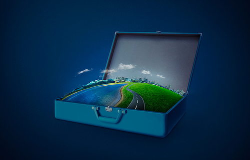City skyline, green field, lake, mountain and curvy asphalt highway in an open retro vintage suitcase isolated on light blue background . Night scene .