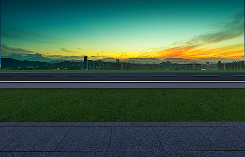 Side angle view empty asphalt road with grass ,stone marble floor and sunrise background . Mixed media .