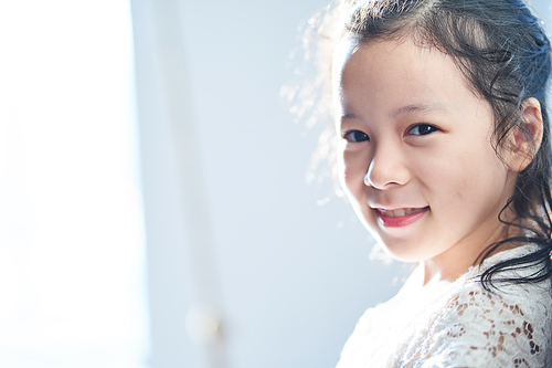 Closeup portrait of pretty little asian girl smiling