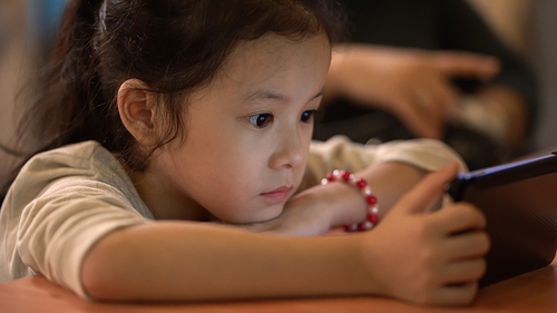 Asian little girl focus watching smartphone