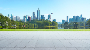 Empty floor with park and modern cityscape . Morning scene .