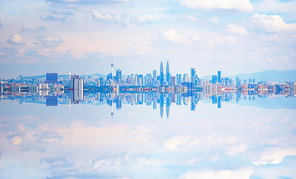 Kuala Lumpur city skyline with stunning reflection in water .