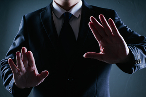 Businessman adjust gesture pose . Low key lighting .
