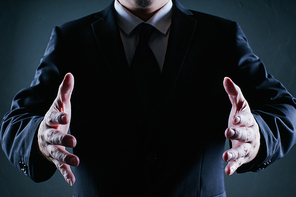 Businessman hold gesture pose . Low key lighting .