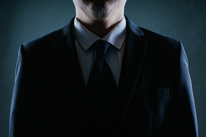 Businessman close up pose . Low key lighting .
