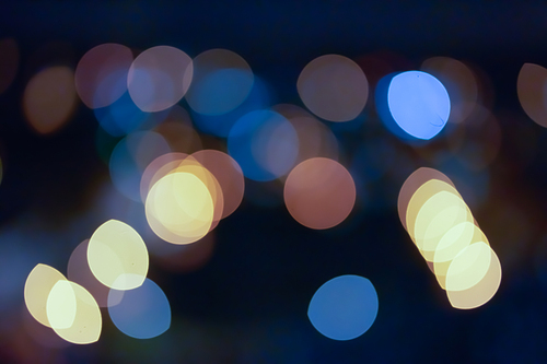 Abstract blue bokeh with dark background.