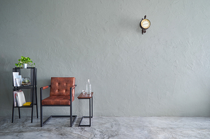 Loft style interior design  with brown armchair,tea table and iron bookshelf .