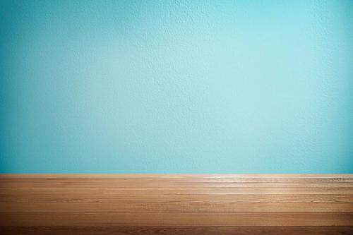 Wood table with mint blue background .