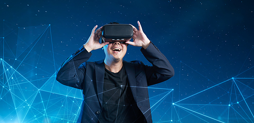 Asian businessman be excited during the view of VR experience with smart circles and lines network connection background