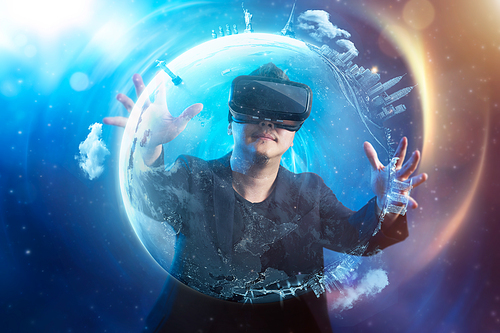 The young man wearing virtual reality goggles with amazing cosmic futuristic space virtual imaging background .