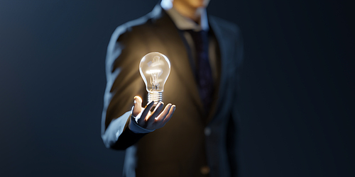 Business man hold the glowing light bulb. Innovation, Creative, inspiration and brainstorming solution concept. 3d rendering