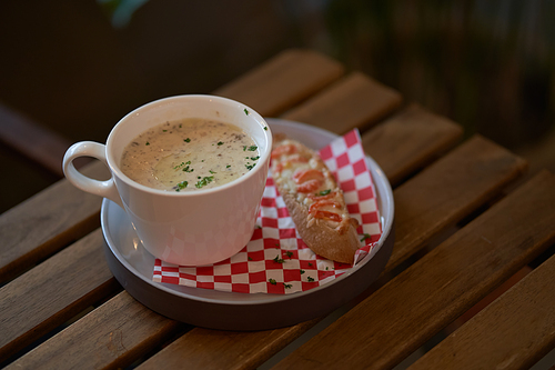 Mushroom soup with bake bread on wooden table . Top view