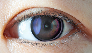 Closeup of camera len inside the women eye , futuristic digital vision technology concept .