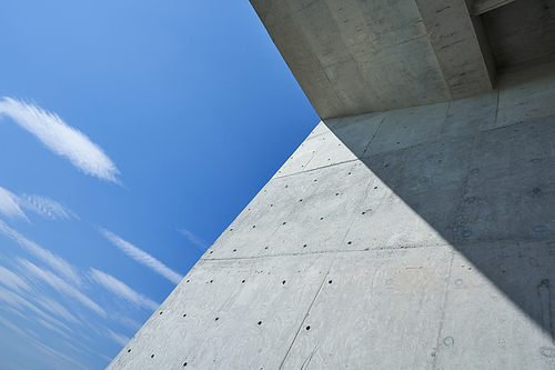 Abstract geometric view of modern building with blue sky .